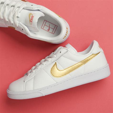 Nike shoes with gold swoosh